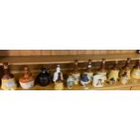 A Collection of empty bells and flagon decanters to include small grouse design flagon- full and