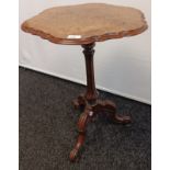 Burr walnut side table, the moulded pie crust edge, above a baluster column raised on a trio of