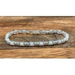 A Silver CZ & Opal paneled line bracelet. [18cm in length]