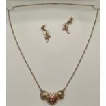 A 10ct gold leaf designer pendant, chain and earring set.
