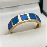 A Ladies 9ct yellow gold ring set with blue opals. [Ring size O] [2.60Grams]