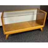 Vintage Cooperative haberdashery shop display counter, with a light wood frame and glass front and