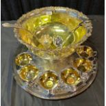 A Large silver plated ornate punch bowl, tray, cups and ladles