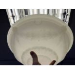 An Art Deco milk glass ceiling shade with metal trim fitting. [40.5cm in diameter]