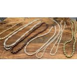 A collection of 7 pearl necklaces to include a brown pearl necklace with a 14ct gold clasp, Green