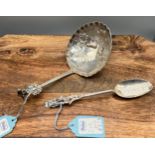 A Large antique Dutch silver ladle together with a rubbed silver ornate spoon.