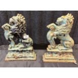 A Pair of antique cast iron lion door stops.