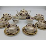 20th century 22 piece batwing tea set, the royal blue ground decorated with flowers, foliage and a