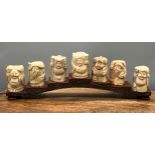 A collection of 19th century Japanese bone carved figures of seven gods. Signed by the artist to the