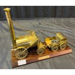 A Vintage Stephenson's Rocket brass engine and cart model.