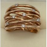 A 9ct rose gold ladies wire style ring fitted with 7 diamonds. [Ring size O] [7.82grams]