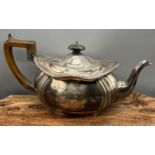 A London silver ornate tea pot with wooden handle. Engraved with Initial 'H' to the front panel.