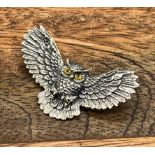 A silver owl in flight brooch stamped 925. (4cm wing to wing)