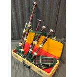 A Set of vintage Scottish bagpipes. Comes with carry case.