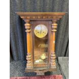 Antique wall clock. Fitted with a brass ornate face. Comes with a key and pendulum.