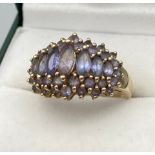 A Ladies 9ct yellow gold ring set with pale purple stones. [Ring size M] [4.66Grams]