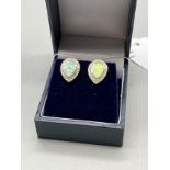 A Pair of silver stud earrings with opal panels.