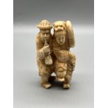 A Japanese Meiji period ivory carved figure of a man and women dancing. Signed to the back. [8cm