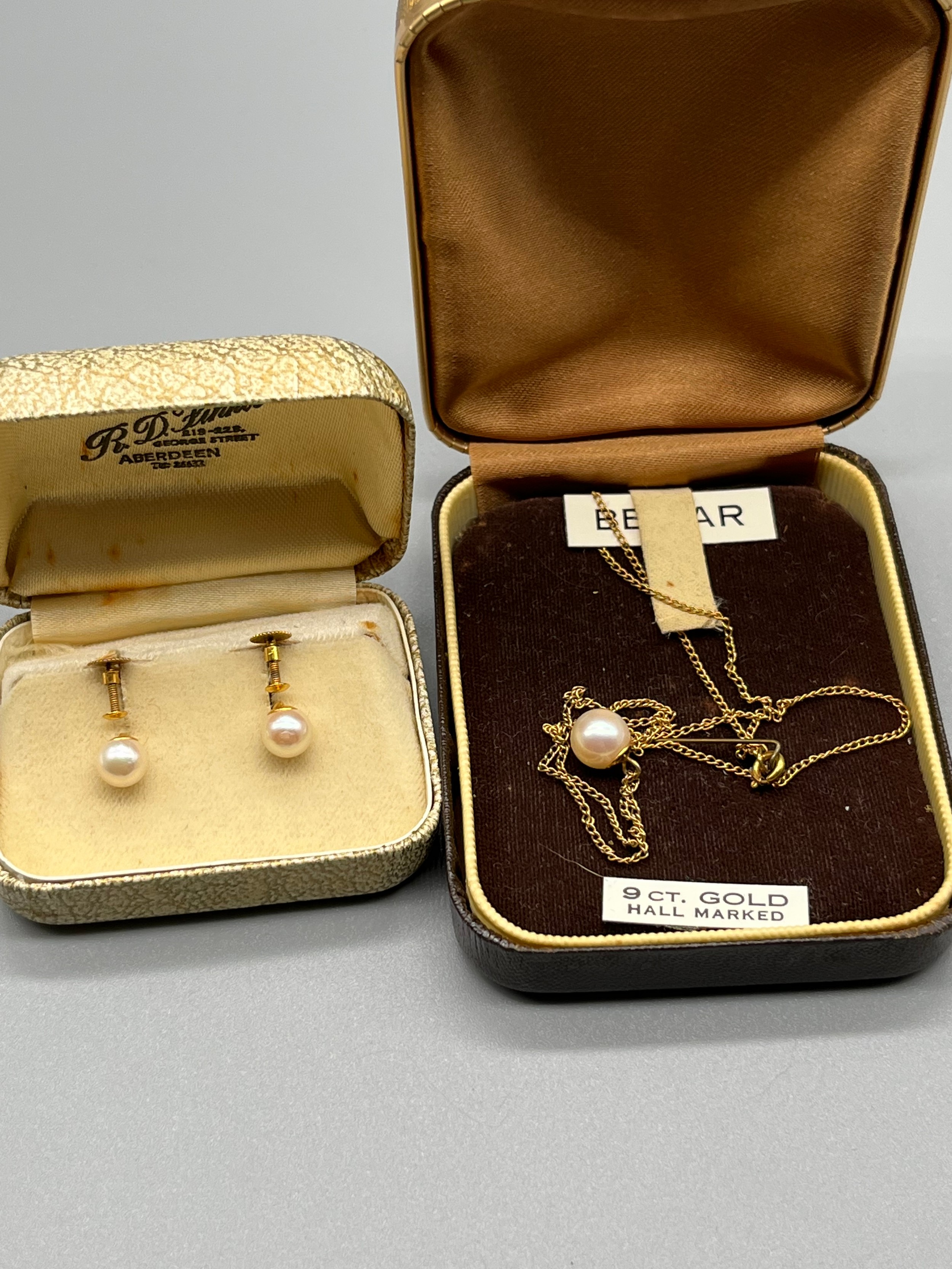 A 9ct gold and pearl set pendant with matching earrings.