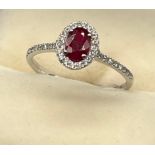 An 18ct white gold ruby and diamond ring of 85 points [Rings size O] [1.79Grams]