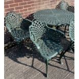 A Heavy cast metal garden table with 6 matching cast metal chairs.