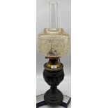 Antique cast metal, brass and glass paraffin lamp.