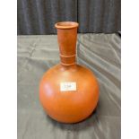 A Chinese terracotta/ clay bulbous vase with long neck.