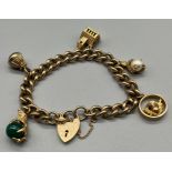 A 9ct gold charm bracelet, attached with various charms to include ball and claw charms. [51.