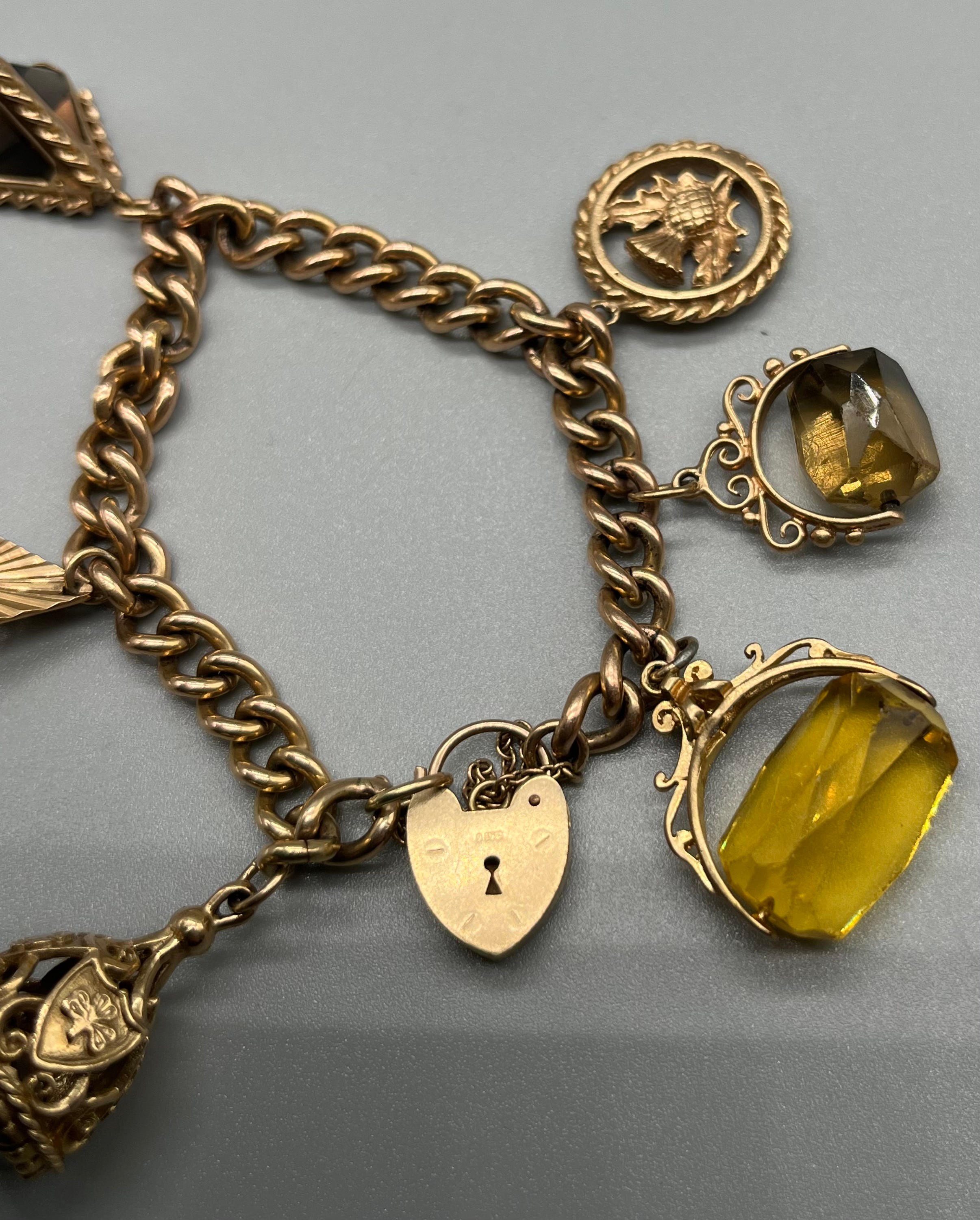 A 9ct gold charm bracelet, attached with various fob charms. [43.04grams] - Image 4 of 5