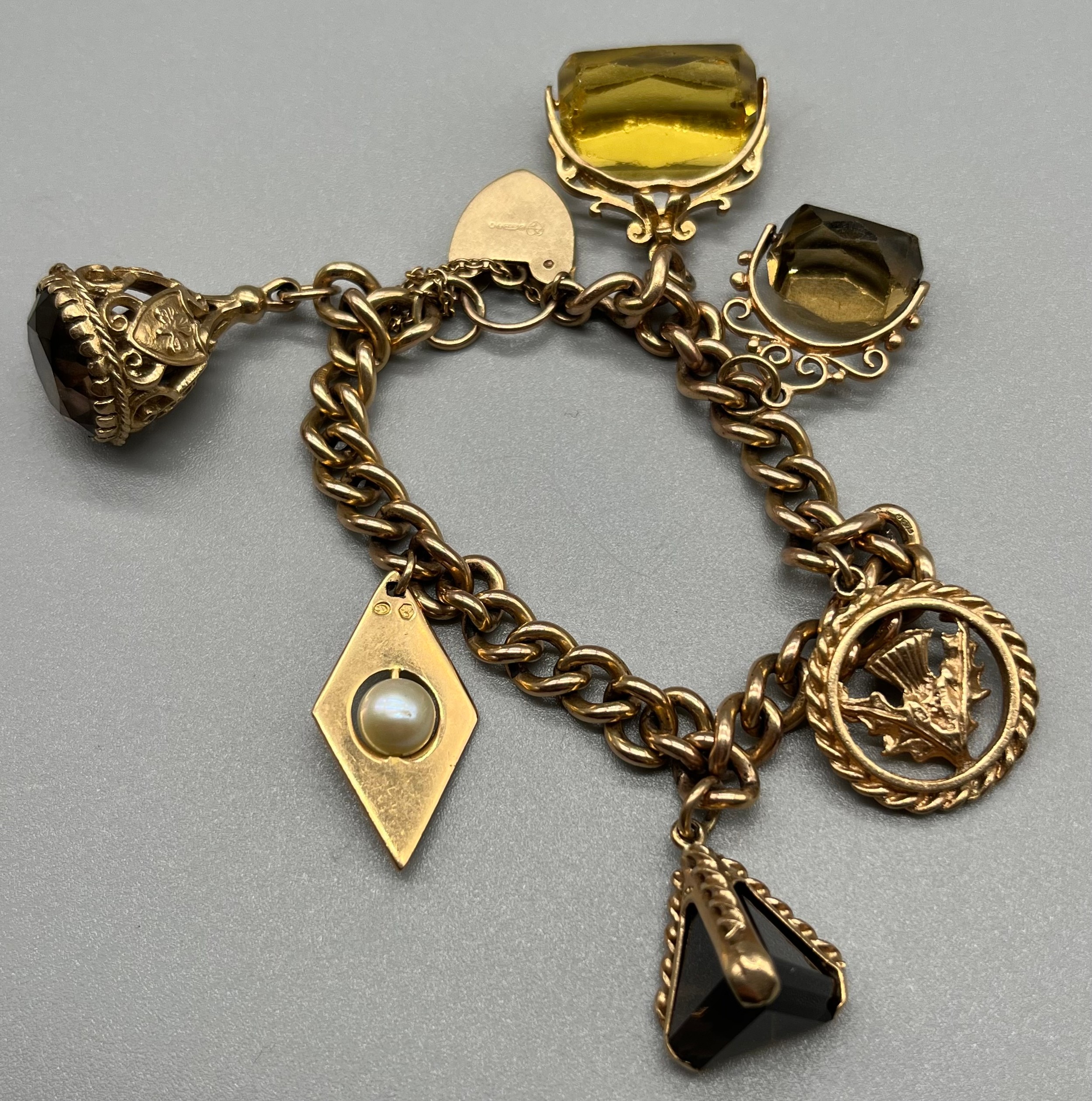 A 9ct gold charm bracelet, attached with various fob charms. [43.04grams] - Image 5 of 5