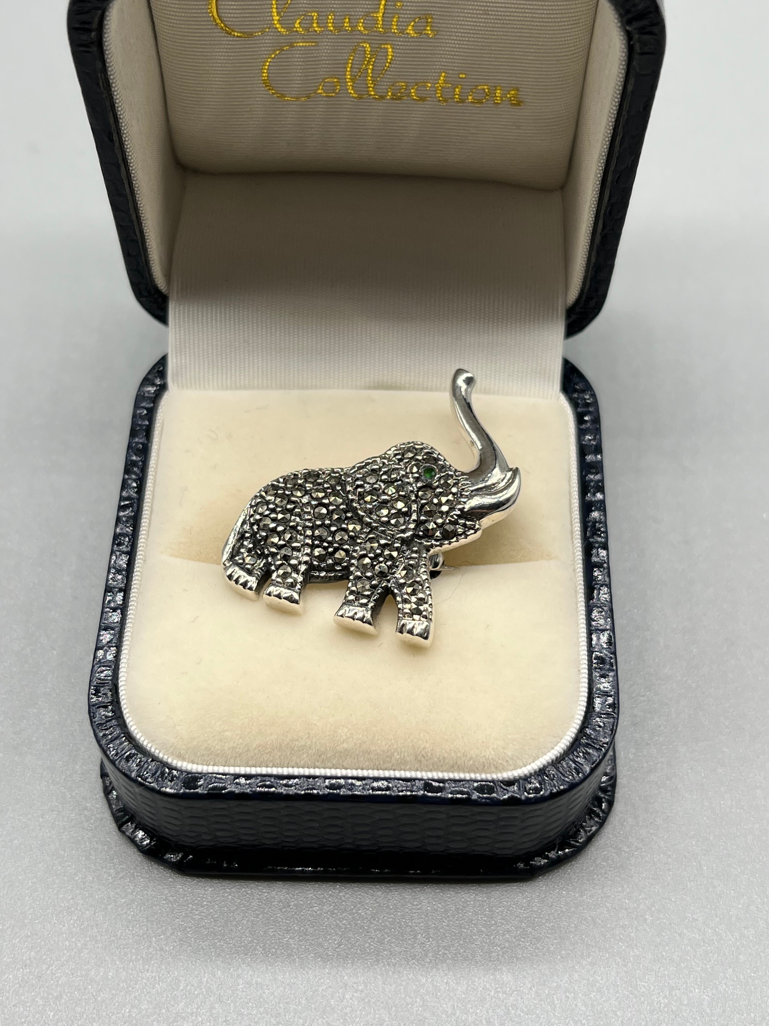 A Silver and marcasite elephant brooch/ pendant.