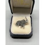 A Silver and marcasite elephant brooch/ pendant.