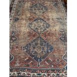 A Large Persian style hand woven rug. [Worn in areas][331x231cm]