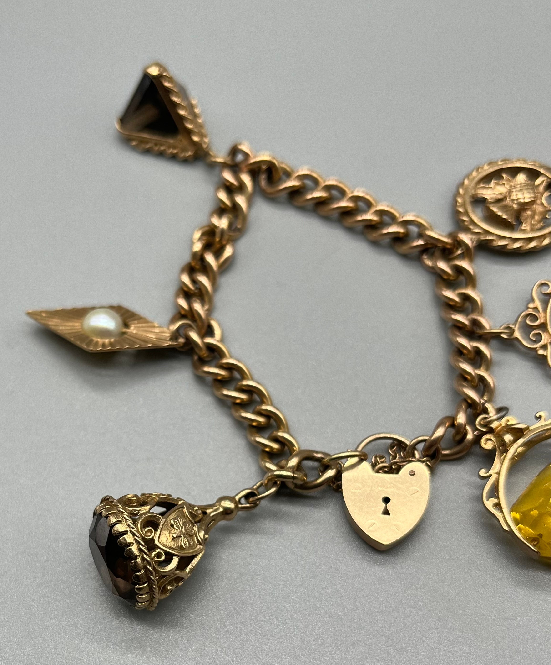 A 9ct gold charm bracelet, attached with various fob charms. [43.04grams] - Image 3 of 5