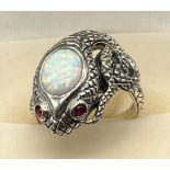 A Silver snake ring set with opal panel and ruby eyes. [Ring size Q]