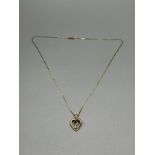 A 9ct gold heart shaped pendant set with a single diamond and comes with a 9ct gold necklace. [1.