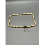 Antique ladies pearl necklace set with a 9ct gold, Amethyst and pearl clasp.