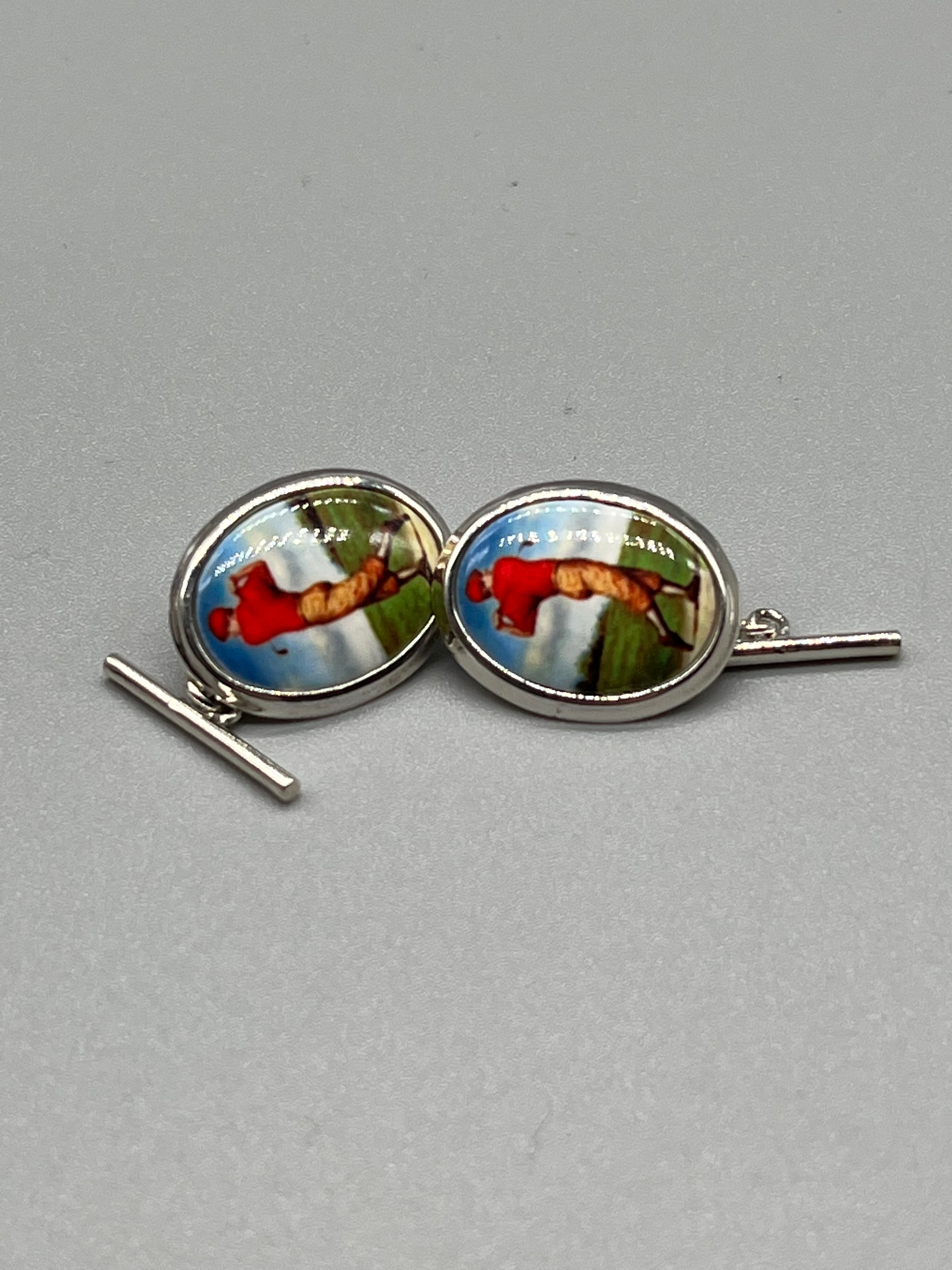 A Pair of silver and enamel golfing cufflinks.