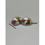 A Pair of silver and enamel golfing cufflinks.