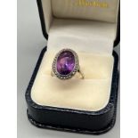 A ladies white metal [foreign stamped] Art Deco ring set with a large Amethyst stone surrounded by