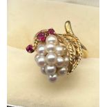 An unusual yellow gold, ruby and cultured pearl dress ring. [6.69grams] [Ring size K]