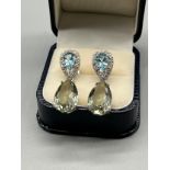 A Pair of silver, CZ and blue topaz drop earrings.