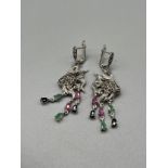 A Pair of silver fish shaped earrings set with sapphire, ruby and emerald's.