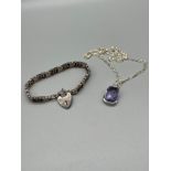 A Silver bracelet with heart lock attached, together with a silver and purple stone pendant with