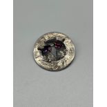 A Scottish Edinburgh silver thistle design brooch. Set with amethyst style stones.