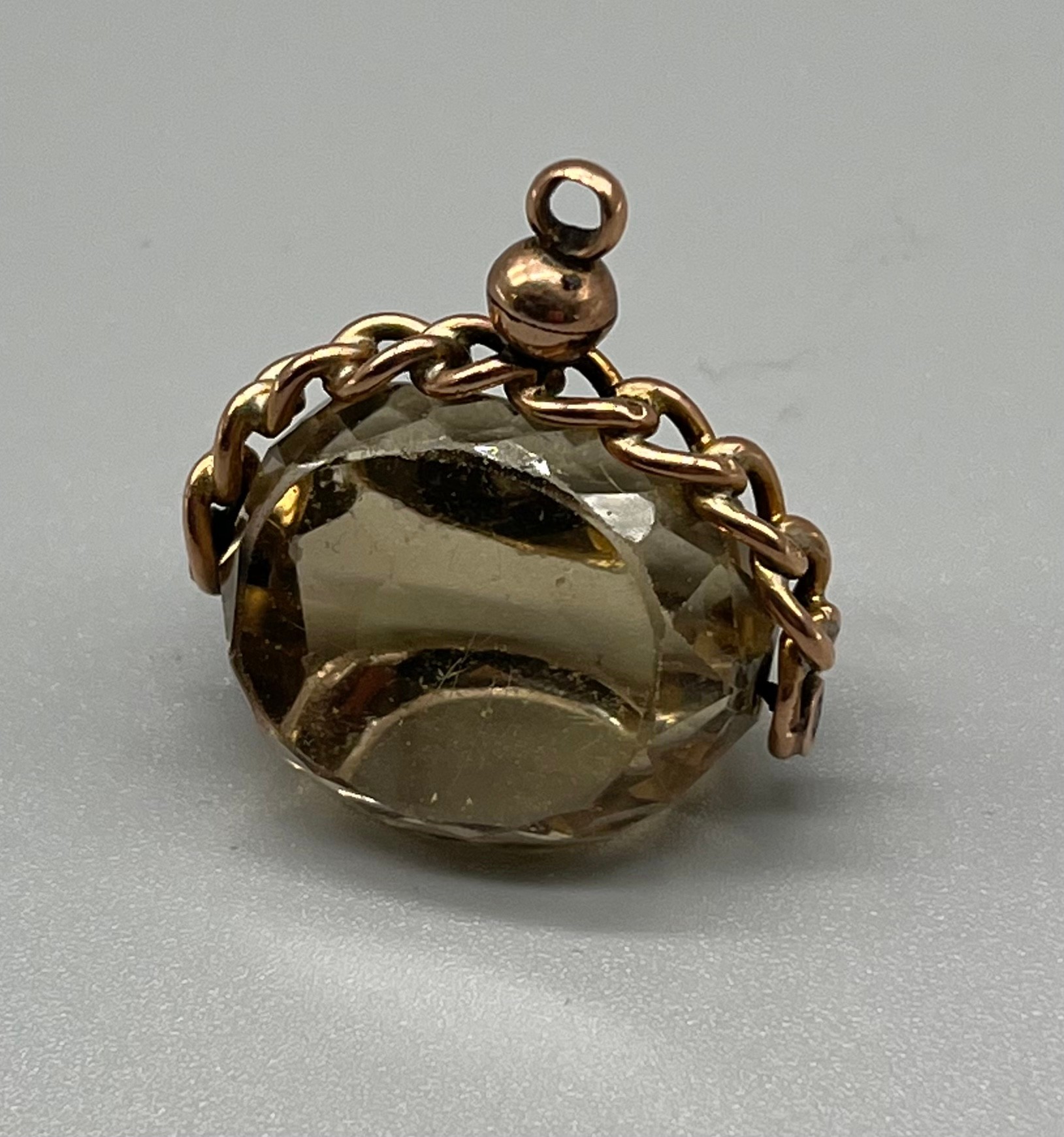 A 9ct antique fob. Swivel smokey quartz style stone. [3.2.8x2cm]