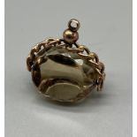 A 9ct antique fob. Swivel smokey quartz style stone. [3.2.8x2cm]