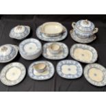 A 19th century ornate blue and white part dinner service to include platters and tureens,