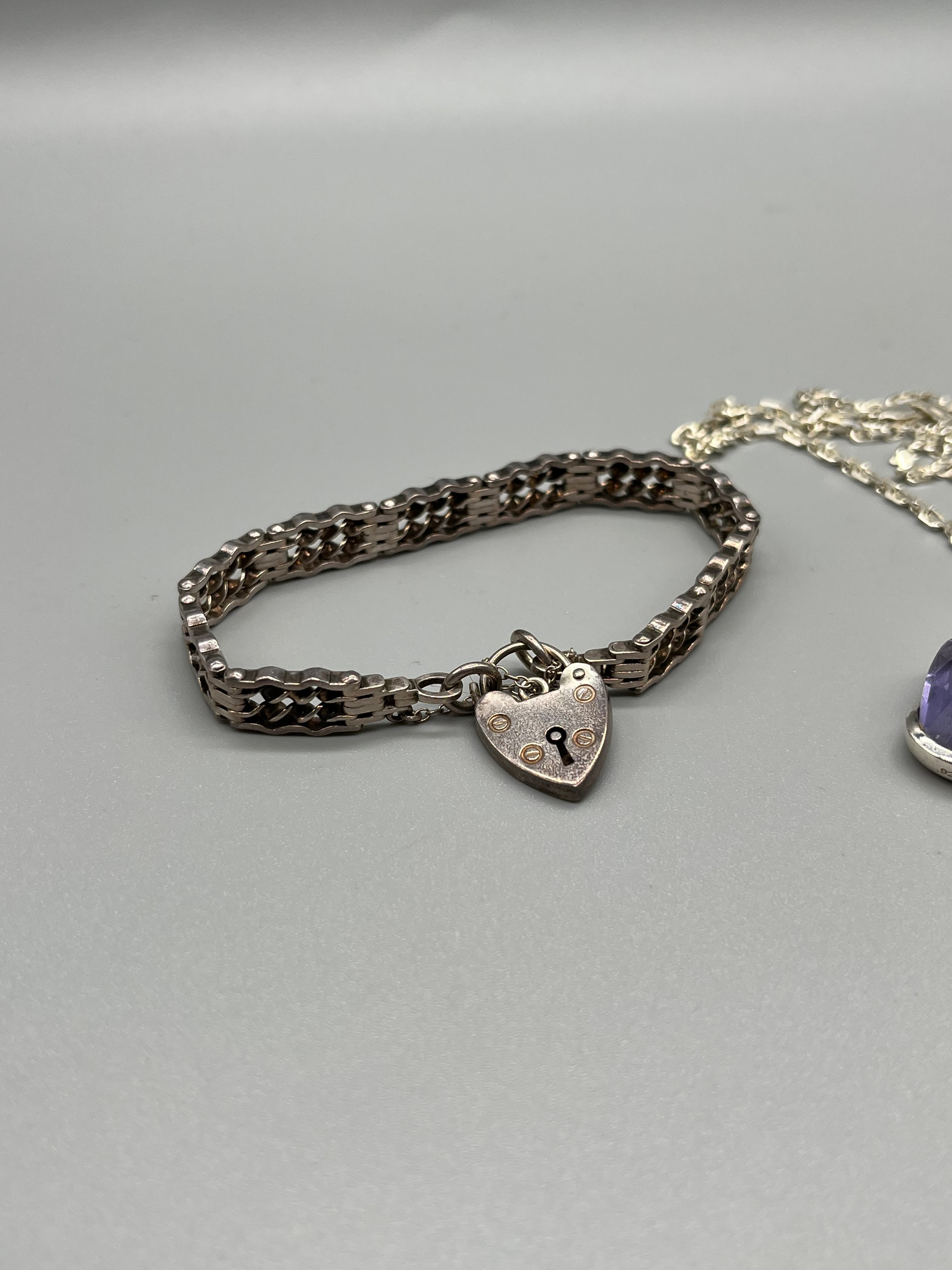 A Silver bracelet with heart lock attached, together with a silver and purple stone pendant with - Image 2 of 3