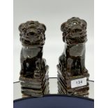 A Pair of Chinese treacle glaze foo dogs.